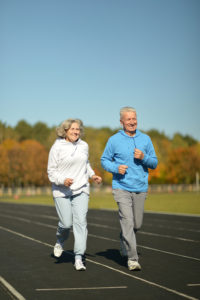 Happy active fit senior couple exercising outdoor