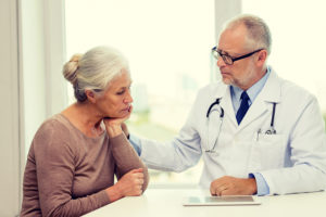 Doctor examining a senior with Long-Covid