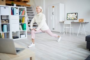 Senior woman lunging at home