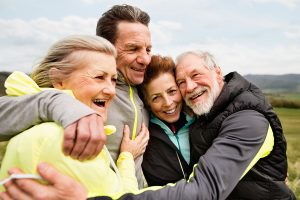 Group of happy seniors bundled up to exercise in cold weather 