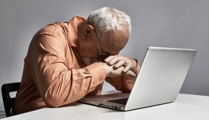Senior sleeping at computer needs to boost energy